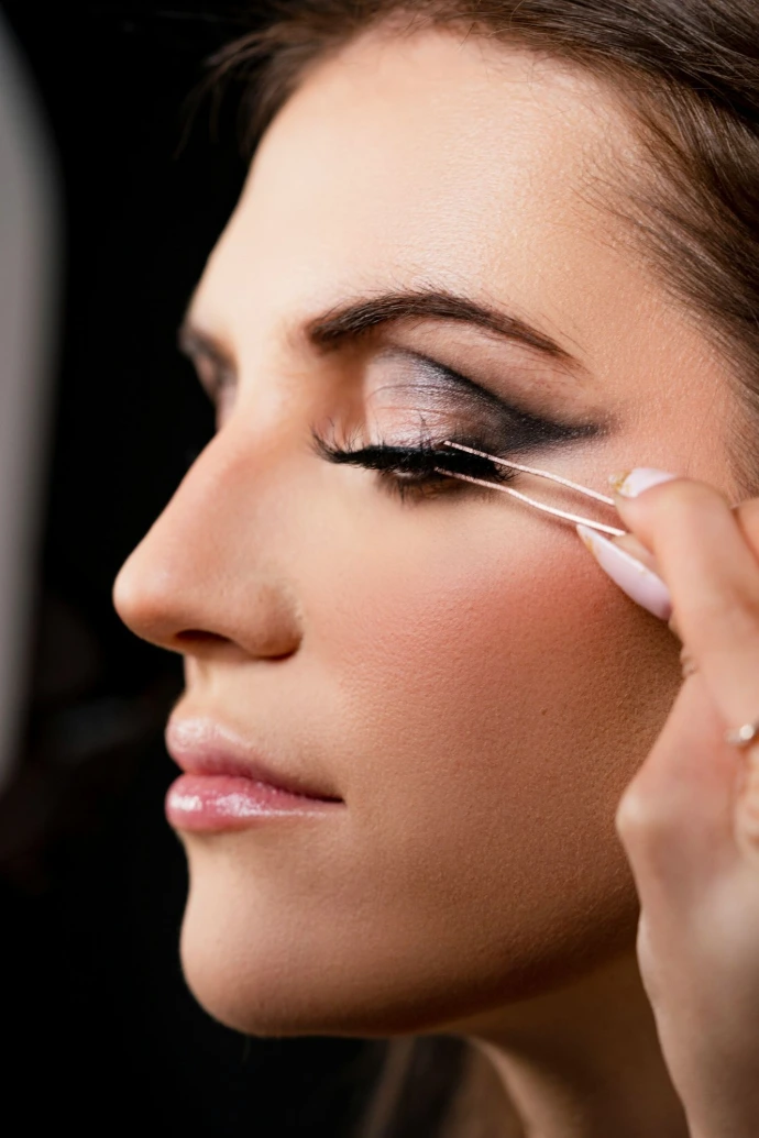 a woman is putting on some makeup Organic Beauty Salon